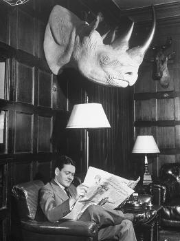 member-reading-newspaper-in-smoking-room-at-the-harvard-club-beneath-a-rhino-head-trophy_u-l-p3pacp0